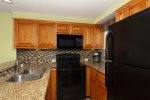 Updated galley kitchen with matching appliances and kitchen amenities